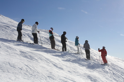 Ski instructor teaching line of skiers